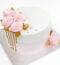 Elegant blush pink cake decorated with roses, perfect for weddings and anniversaries