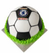 Football theme cake shaped like a soccer ball with green icing base