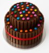 KitKat Chocolate Cake with KitKat bars around the sides and colorful gems topping, eggless and freshly baked in Yelahanka.